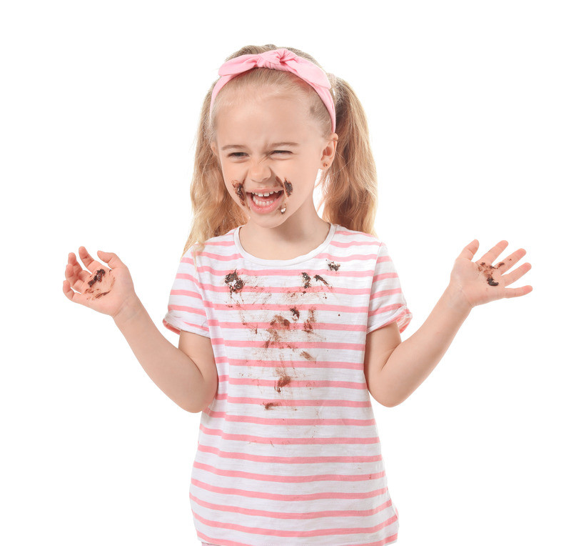 Little girl with chocolate stains on her clothes