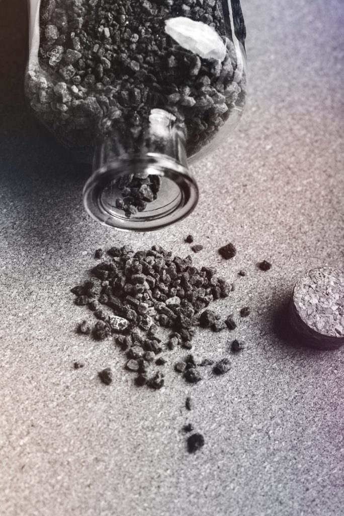 visual representation of a glass jar filled with activated charcoal granules