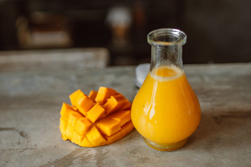 diced mangoes accompanied by pulpy mango juice