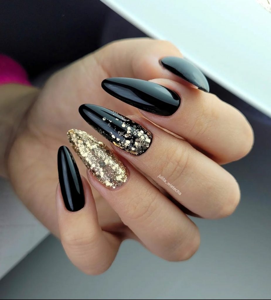 Black matte nails with gold flake glitter 