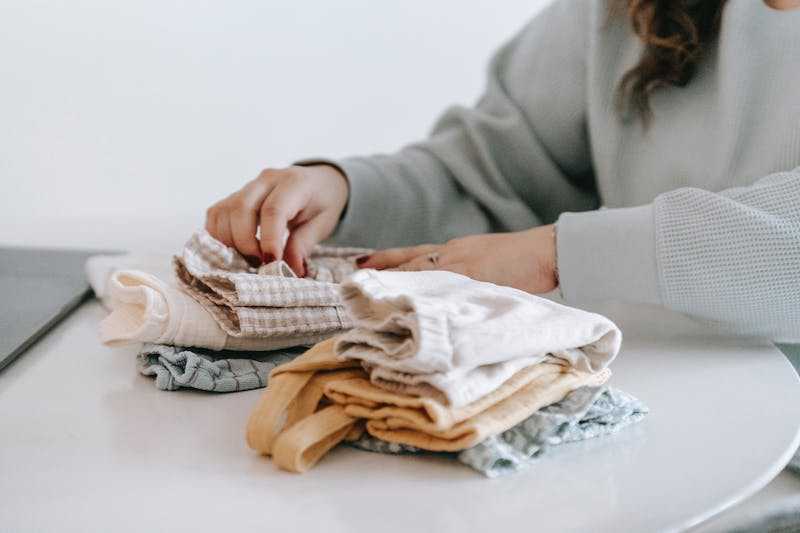 Woman folding baby clothes 