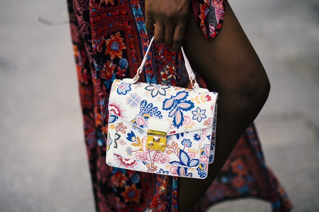 a woman holding washable floral handbag