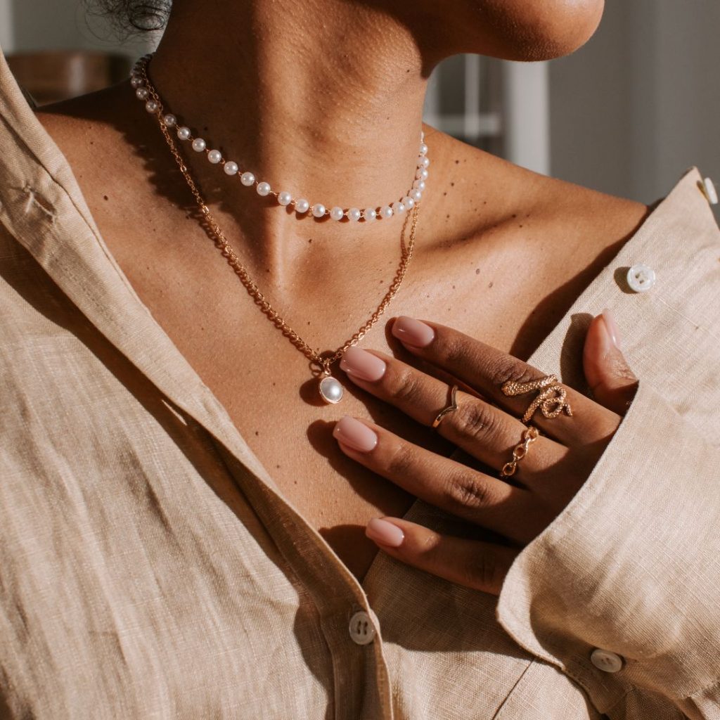 woman in layered necklaces