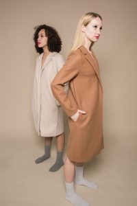 Two women wearing coats