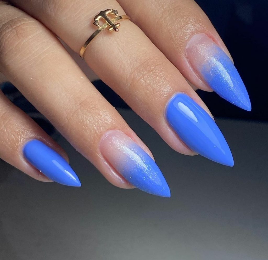 Blue stiletto nails with glitter dust 