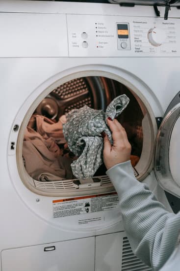 putting clothes in washing machine