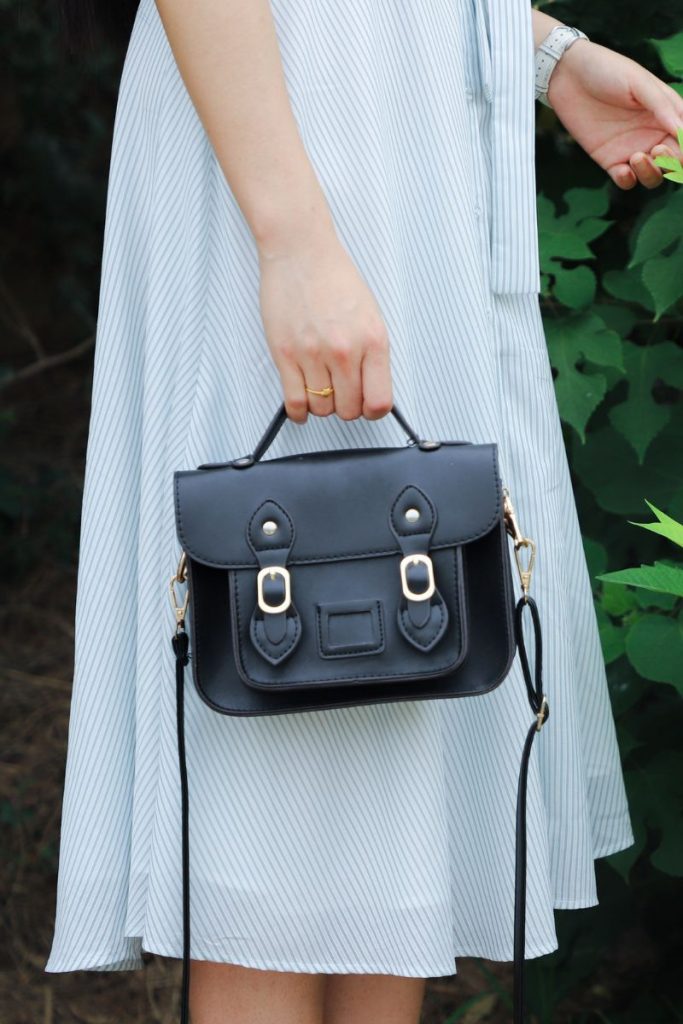woman in black leather bag