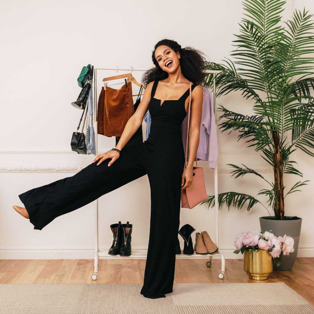 woman in black jumpsuits and a rack of clothes