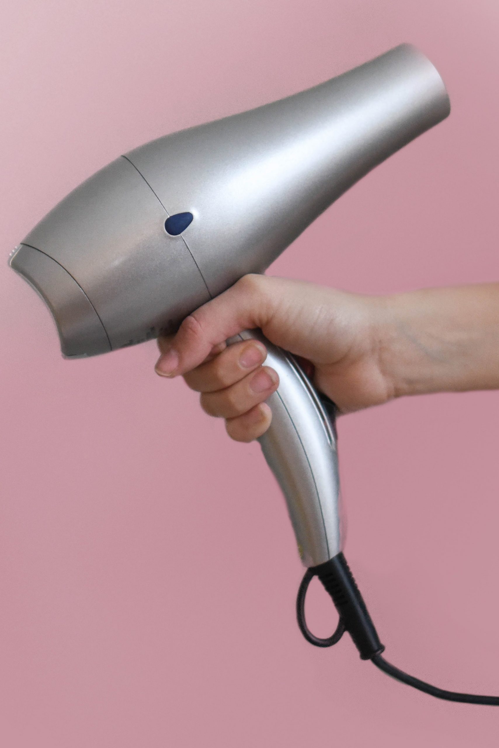 Person holding hair dryer