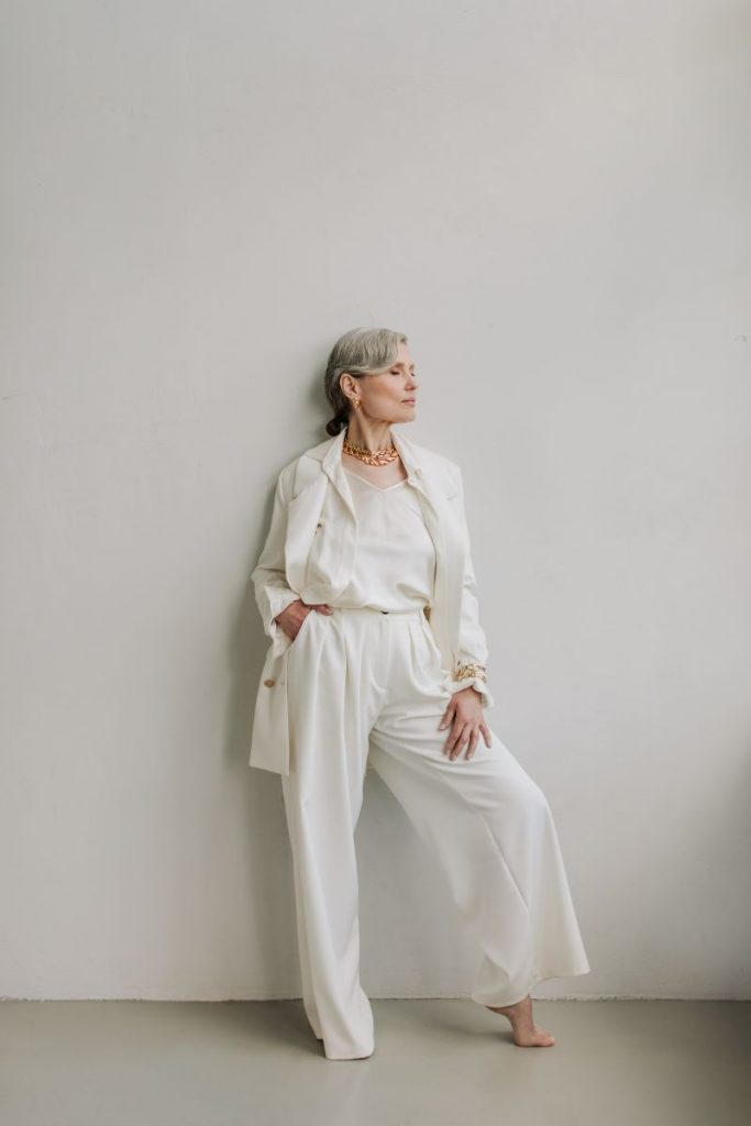 older woman in a white outfit