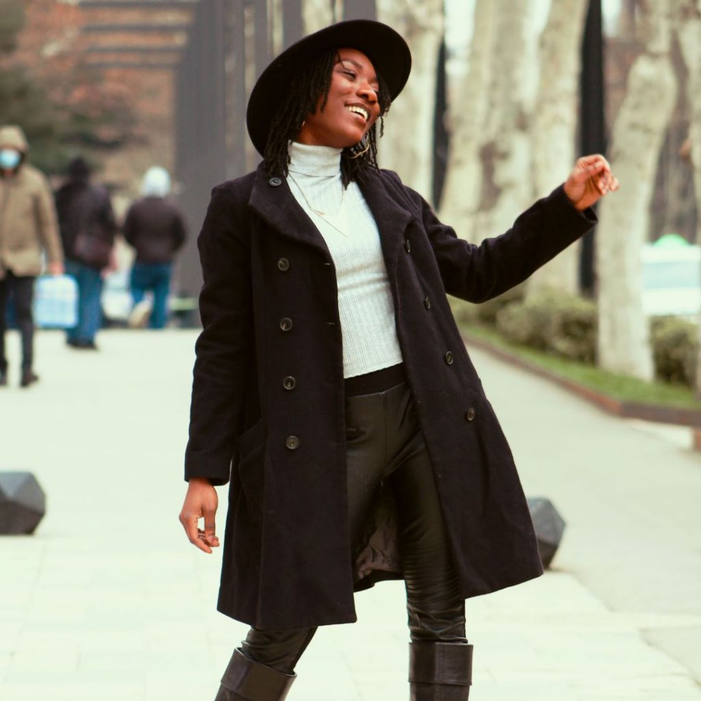 woman in a long black coat