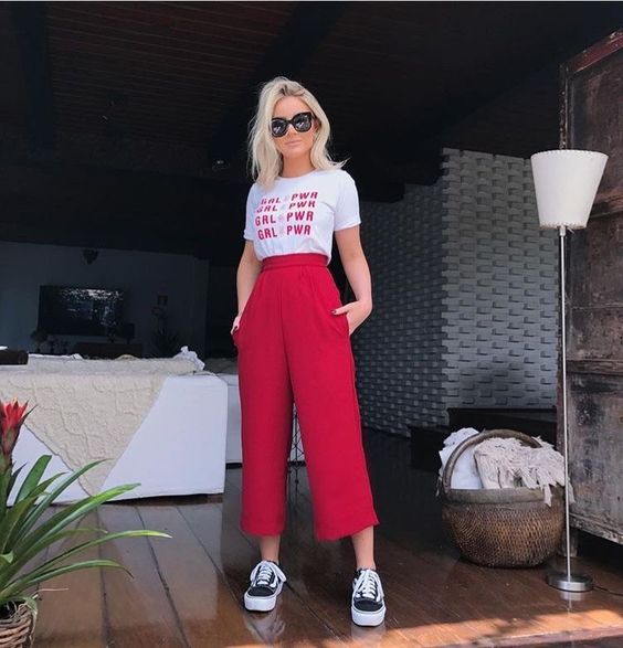 White graphic tee with red trousers 