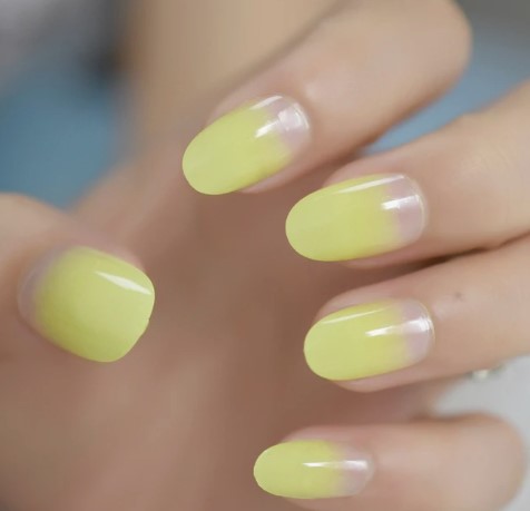 Refreshing lemon-inspired ombre nails with seamless yellow blend.
