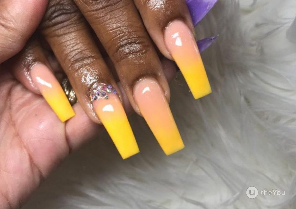 Yellow and peachy-orange ombre nails.
