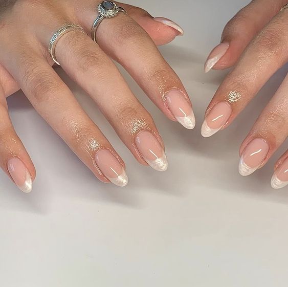 Enhance your pearl-inspired style with shimmery ivory French nails.