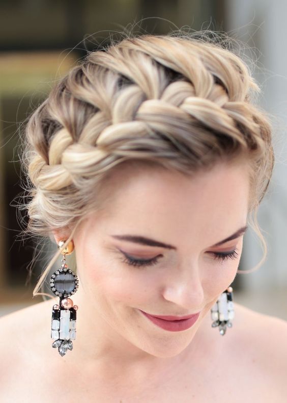 Regal and charming bridal hairstyle, adorned braided crown.