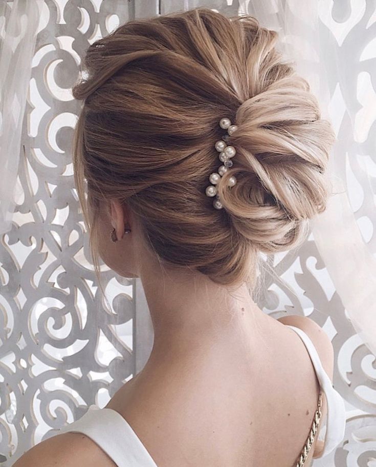 Timeless bridal hairstyle with graceful chignon twist.