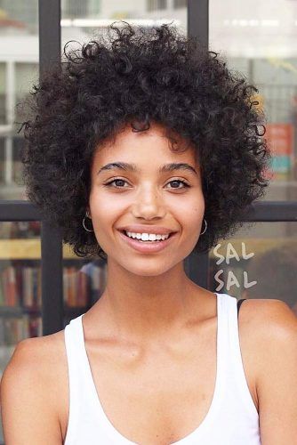 Natural curls in a short, voluminous, and statement-making style.