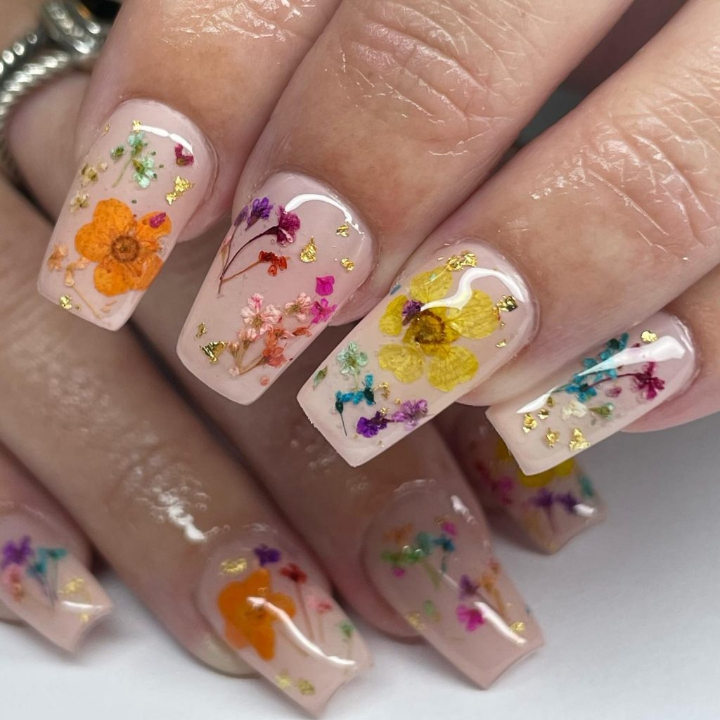 Nails showcasing preserved flowers for a unique look.
