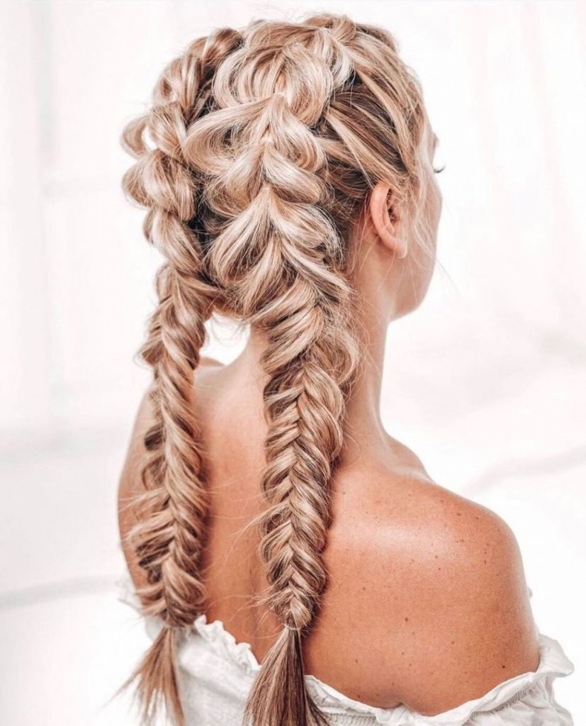 Curly hair styled in an intricate fishtail pattern.