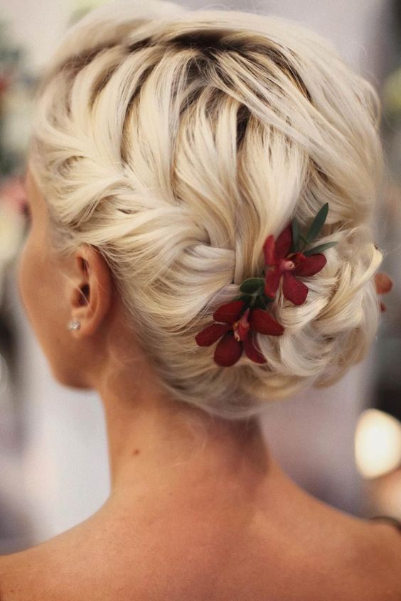 Bridal updo adorned with delicate flowers.