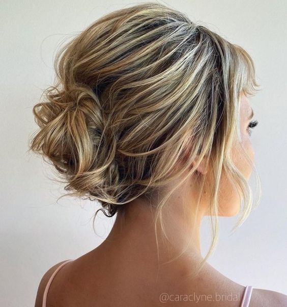 Carefree, romantic, and tousled updo style with a French twist.