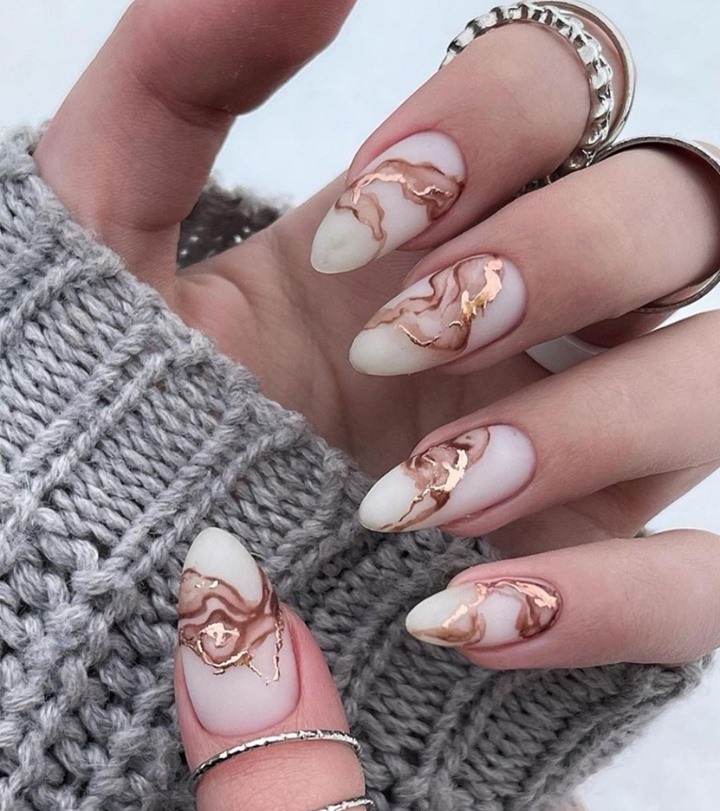 A touch of opulence on marbled nails.