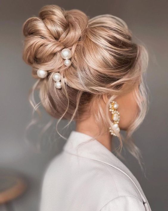 Intricate braided updo with pearls adorned.