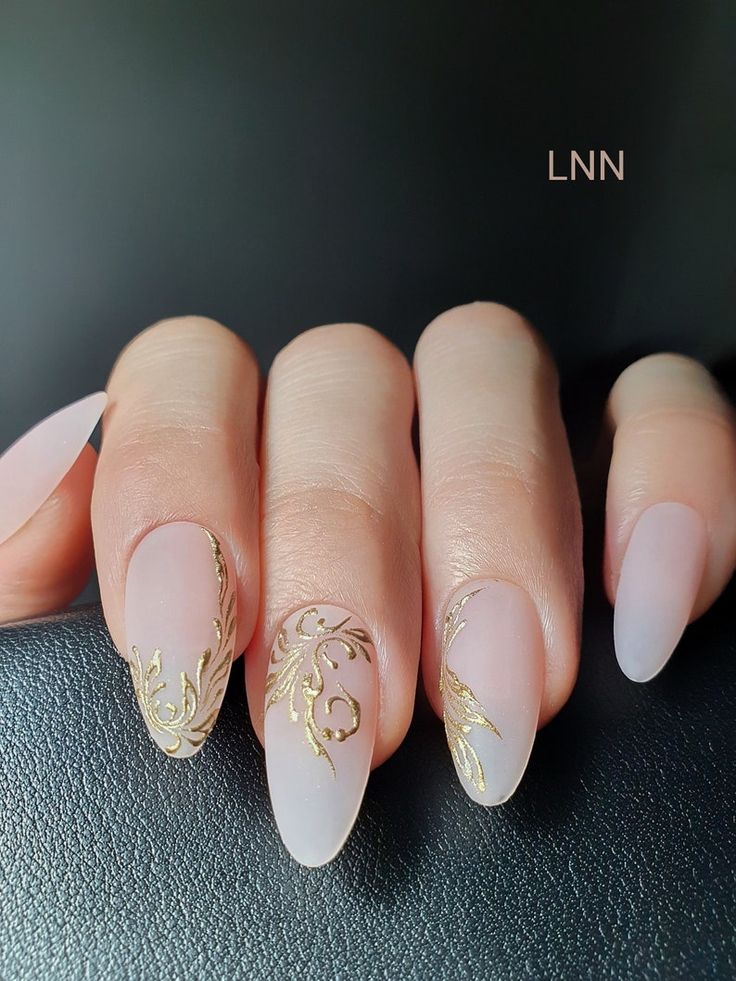 Nude gradient nails adorned with gold accents