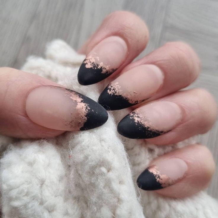 Matte black-tipped nails with a rose gold accent