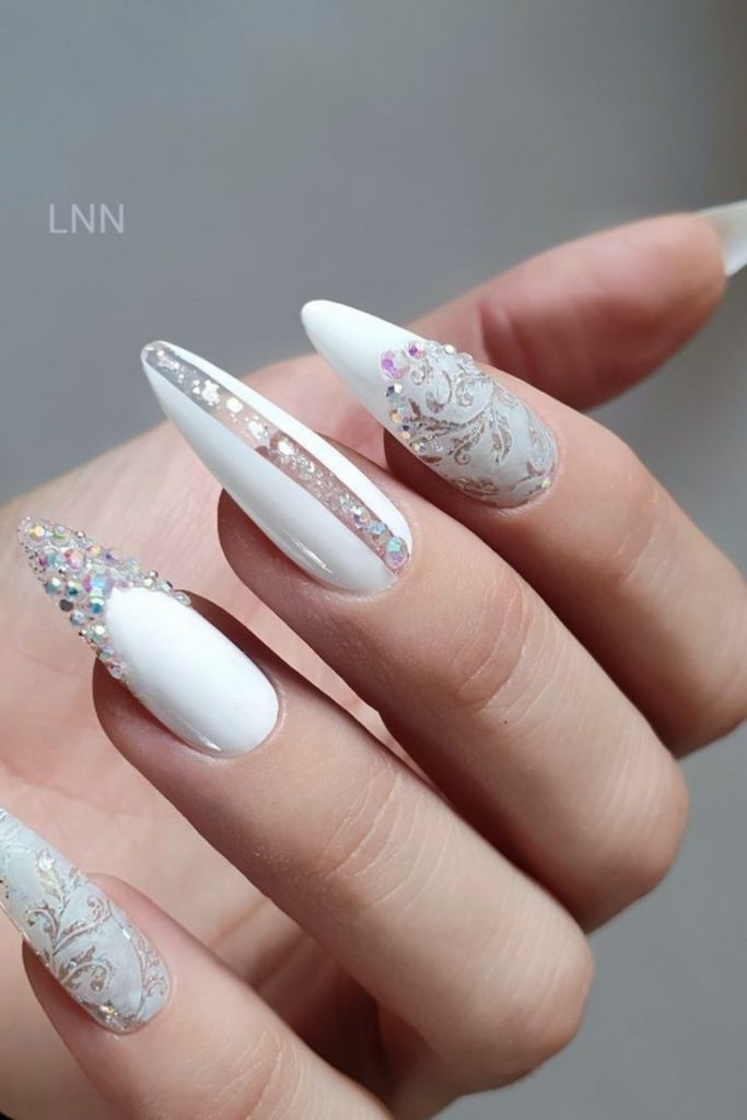 White nails adorned with sparkling rhinestones