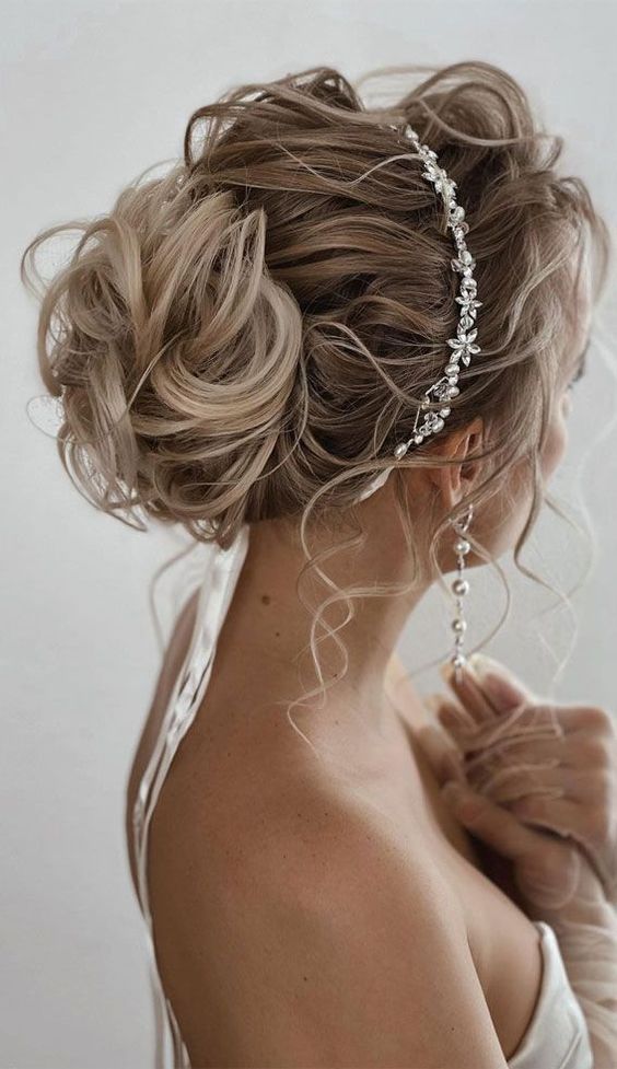 wedding guest hair look with Tousled updo with a hairvine