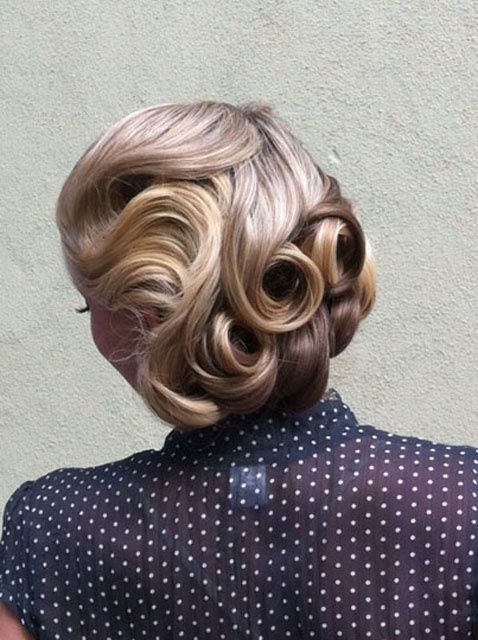 wedding guest hairdo with retro-inspired victory rolls