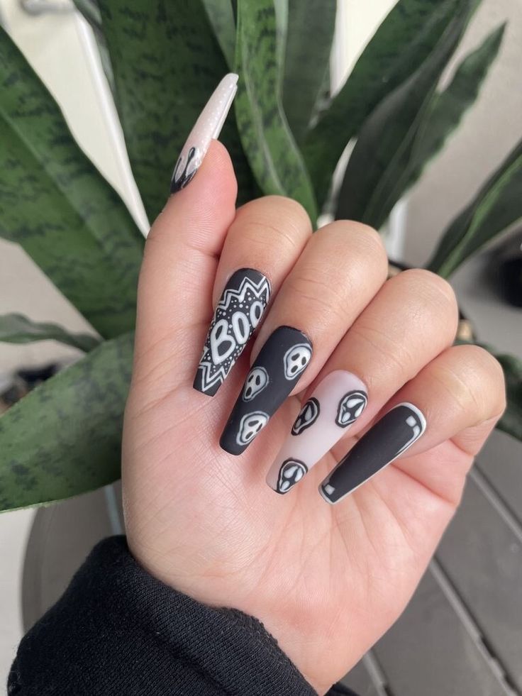 Matte monochrome nails with ghostly screams.