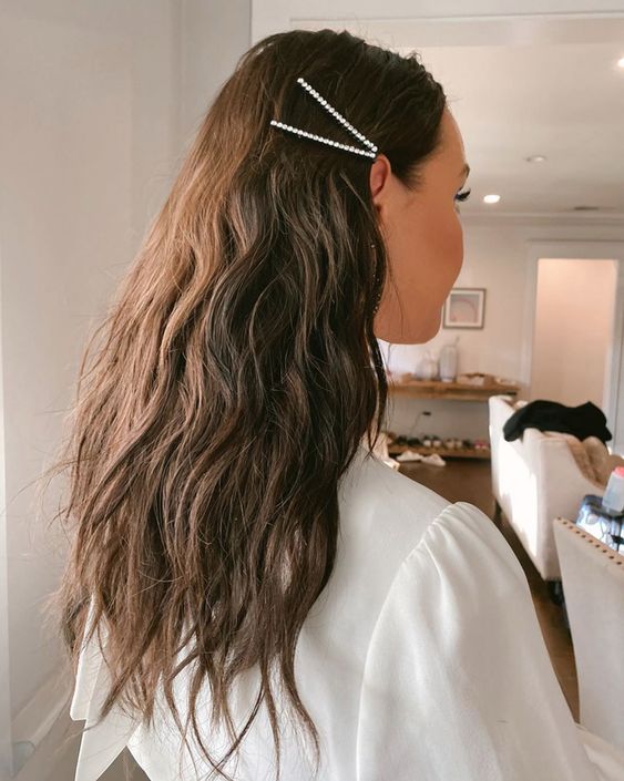 wedding guest hair look inspired loose waves with a sparkly hairpin
