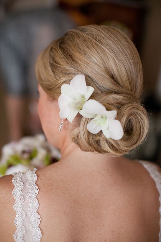Classic low bun with a floral accent
