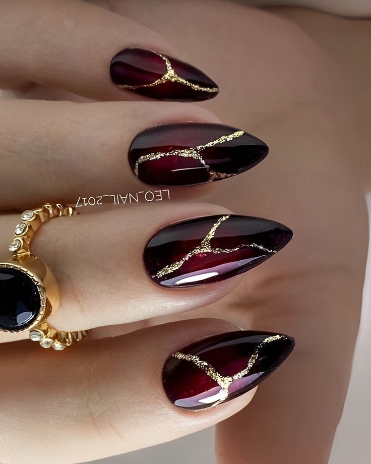 Maroon-black ombre, golden touch almond nails.