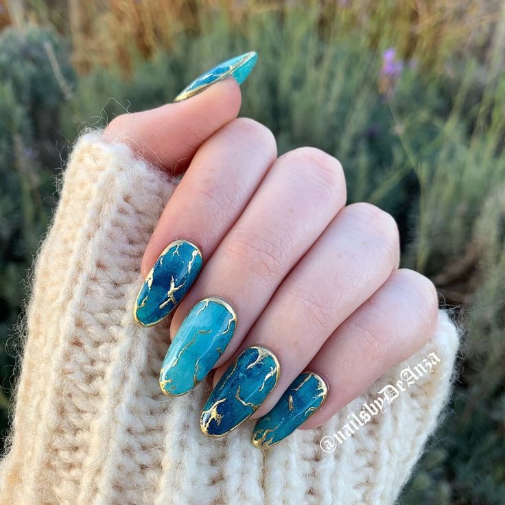 Elegant sea green, golden borders almond nails.