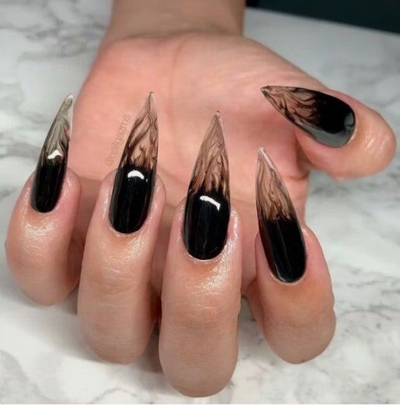 Smokey black gothic design on transparent nails.