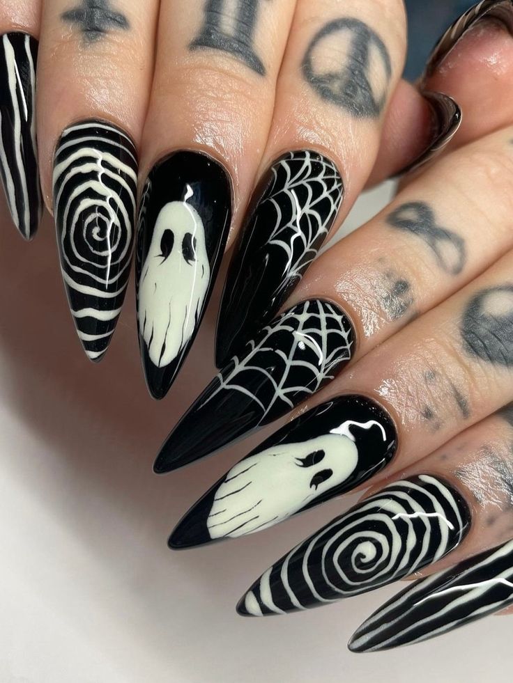 Monochrome nails with spooky white ghost designs.