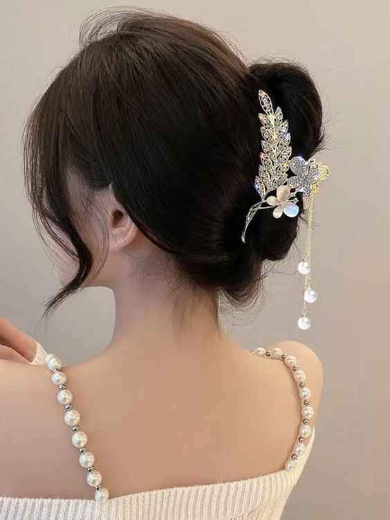 wedding guest hair look inspired tied-up hair with a jeweled claw