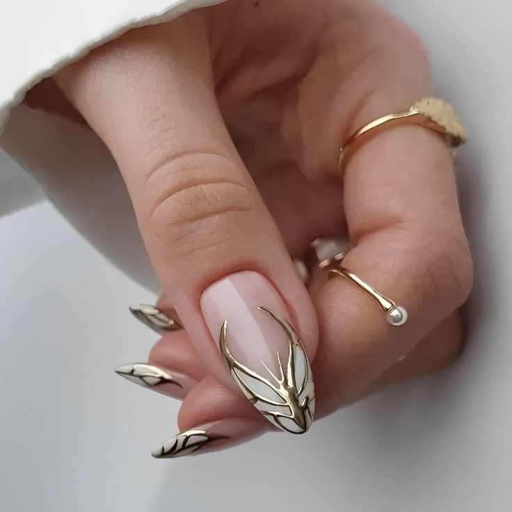White & gold butterfly accented almond nails.