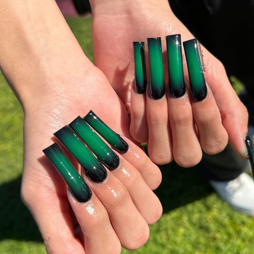 Airbrushed black and forest green square nails.