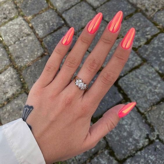 Coral gradient almond nails for a vibrant touch.