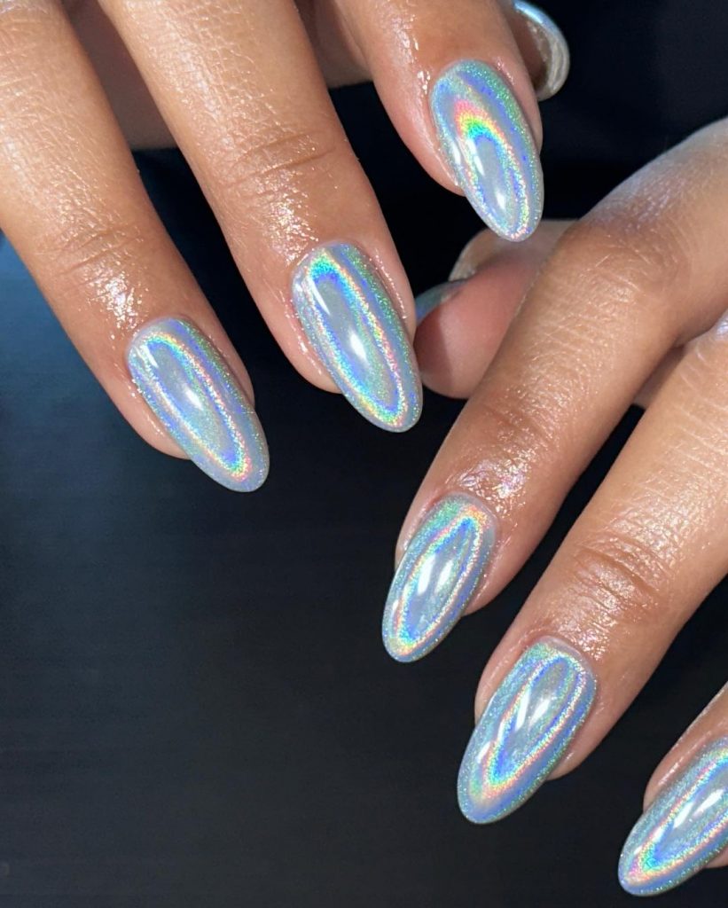 Holographic rounded silver nails.