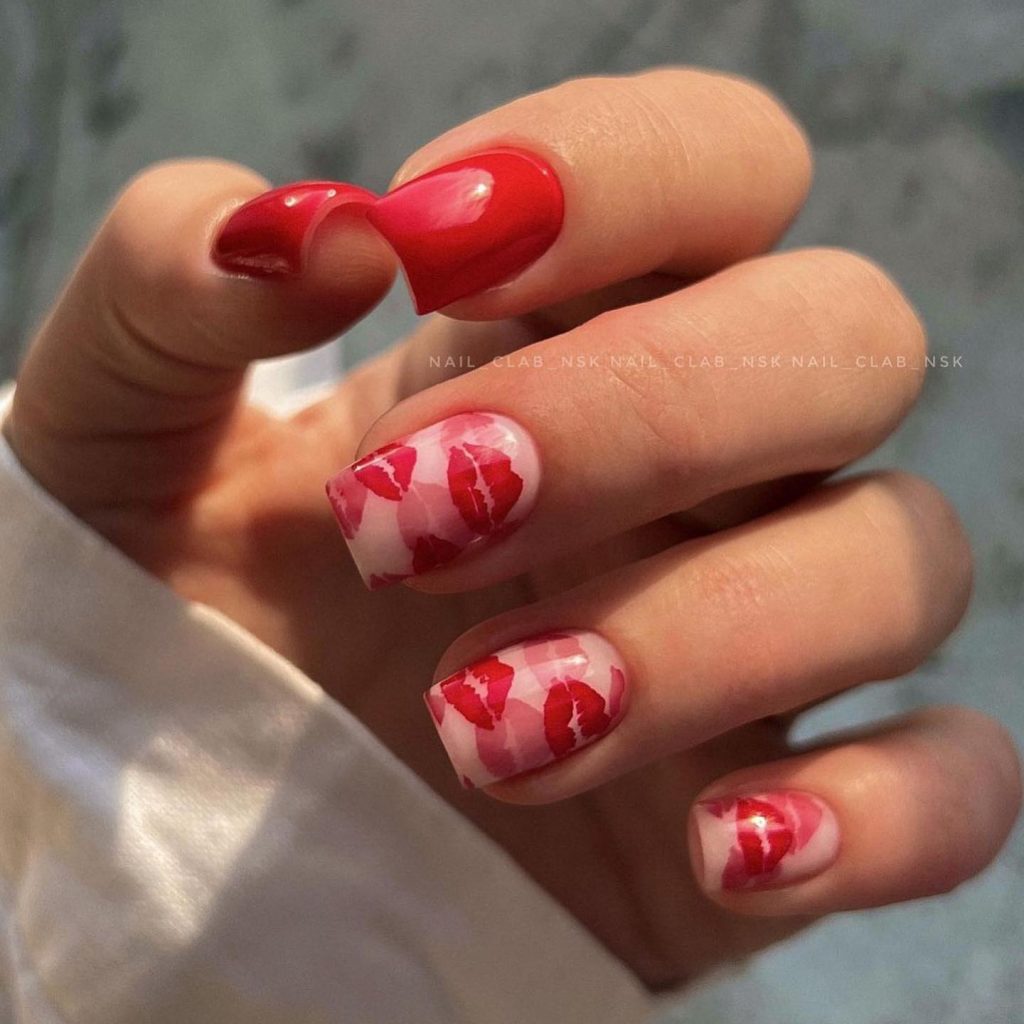 Lip prints in nude and red tones on square nails.