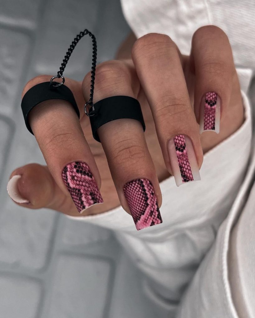 Pink and black scaly snake skin nail art.