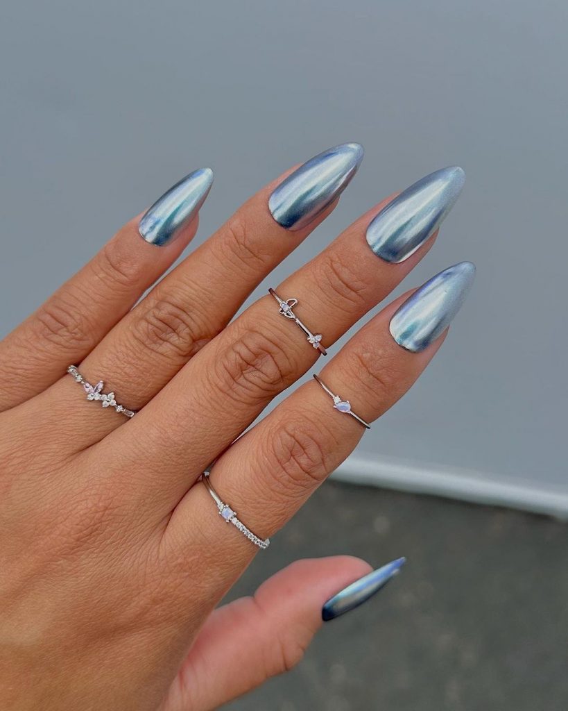 Stardust glazed platinum almond chrome nails.