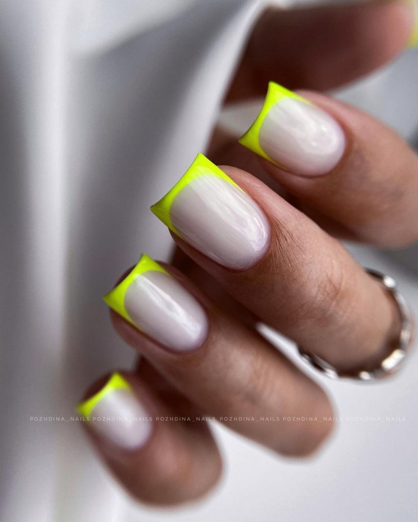 Neon French tip square nails on opal white.