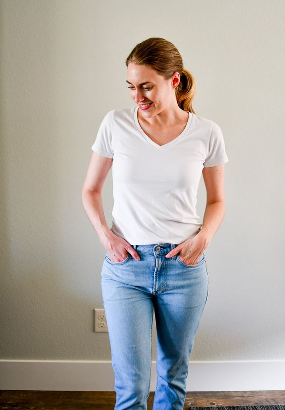 A woman wearing white tee and blue jeans